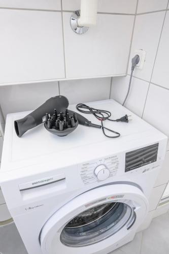 a washer and dryer in a white room with a washing machine at Spacious apartment in Graz for 6 people in Graz