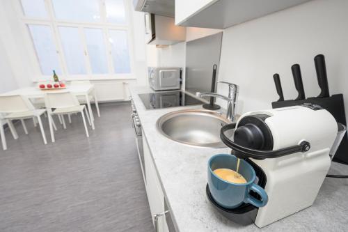 a kitchen with a cup of coffee on the counter at Spacious apartment in Graz for 6 people in Graz