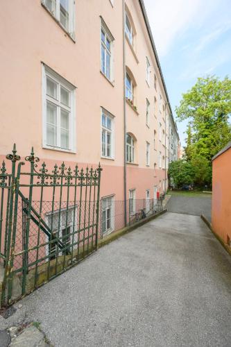a gate in front of a pink building at Spacious apartment in Graz for 6 people in Graz