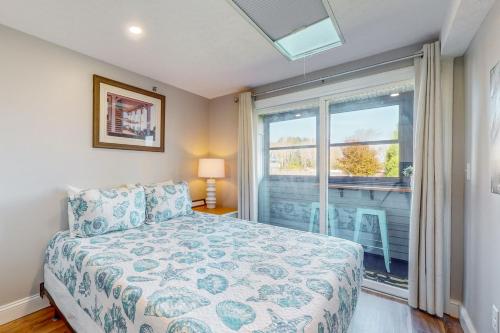 a bedroom with a bed and a large window at 204 at the Shore in Wells
