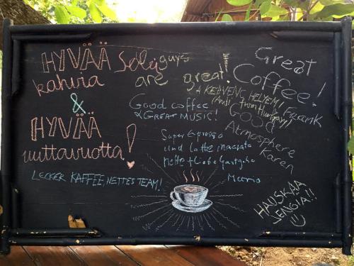 a chalkboard with a cup of coffee on it at Coffee and Resort in Ko Phayam