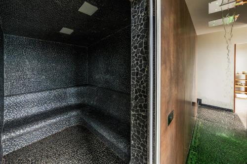 a bath tub in a room with a black wall at Sesta Terra Natural Resort in Framura