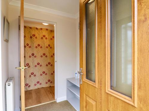 a wooden door in a room with a window at Oakleaves in Colchester
