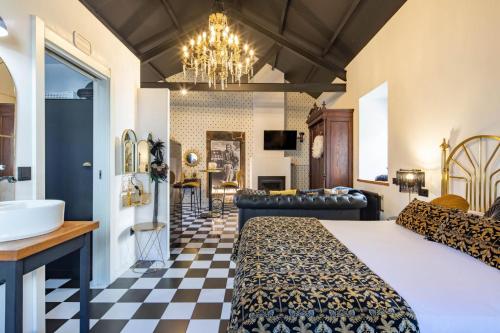 a bedroom with a king sized bed and a bathroom at La Suite Años 20. Bañera, chimenea y terraza. in Corcubión