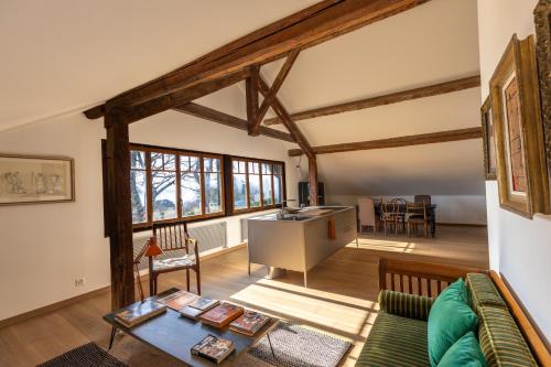 a living room with a couch and a table at 'Le Petit Clos Suites'- Charming Getaway on Leman Lake in Nyon