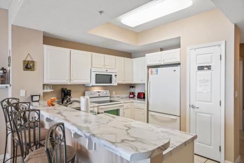 a kitchen with white cabinets and a counter top at Summerwind West 1003 in Navarre