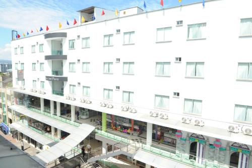 a large white building with flags on it at Hotel San José Plaza in Bucaramanga