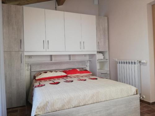 a bedroom with a bed with white cabinets at Appartamenti Cardinali in Assisi