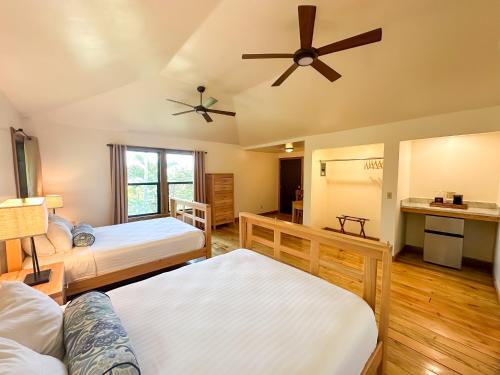 a bedroom with two beds and a ceiling fan at Anthony's Key Resort in Sandy Bay