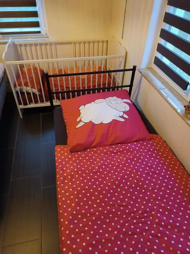 a small crib with a bed with a sheep pillow at Ferienhaus Urlaubstraum in Ueckermünde