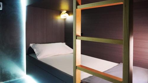 a small room with a bunk bed in it at Hood hostel in Jomtien Beach