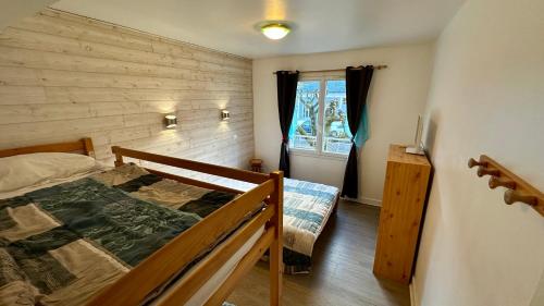 a bedroom with a bed and a window at Le Therminus 42 - Le Mont Dore 8pers in Mont-Dore