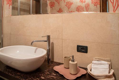 a bathroom counter with a sink and a sink at Centro Storico, Piazza Carmine: La Casa di Angela in Reggio Calabria
