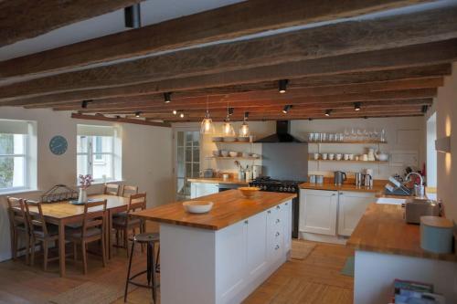 a large kitchen with a table and a dining room at St Margaret's Steps Luxury apartment sleeps 8 in Topsham
