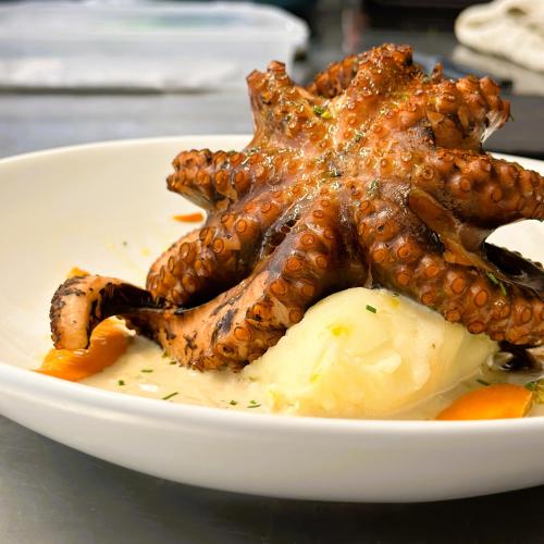 a plate of food with a starfish on top at Ambiance Hotel in Limas