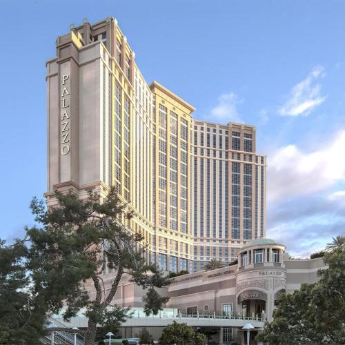 a large building with a sign on top of it at The Palazzo at The Venetian Resort by Suiteness in Las Vegas