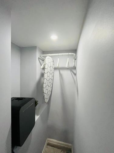 a bathroom with a towel rack and a toilet at Hotel Libertad in Lares