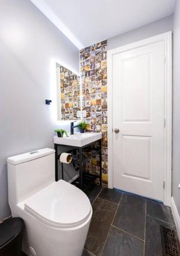 a bathroom with a white toilet and a sink at River Runs Through It in Belleville
