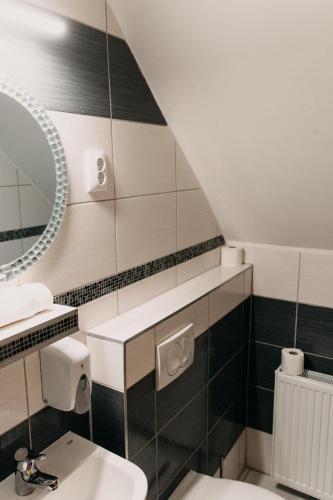 a bathroom with a sink and a mirror at Palma Vendégház in Szeged