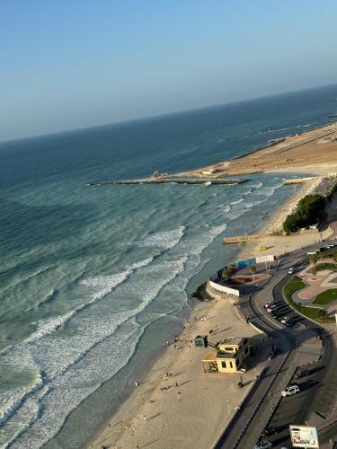 an aerial view of a beach and the ocean at Sunset Beach View Holiday Homes in Ajman 