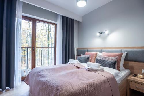 Posteľ alebo postele v izbe v ubytovaní Trevilles Apartamenty - Green Hills