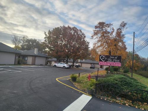 a sign in front of a parking lot with a car at Inn of the Dove - Romantic Luxury Suites with Jacuzzi & Seasonal Fireplace at Harrisburg-Hershey-Philadelphia, PA in Harrisburg