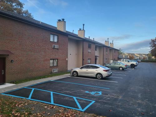 a parking lot with cars parked next to a brick building at Inn of the Dove - Romantic Luxury Suites with Jacuzzi & Seasonal Fireplace at Harrisburg-Hershey-Philadelphia, PA in Harrisburg