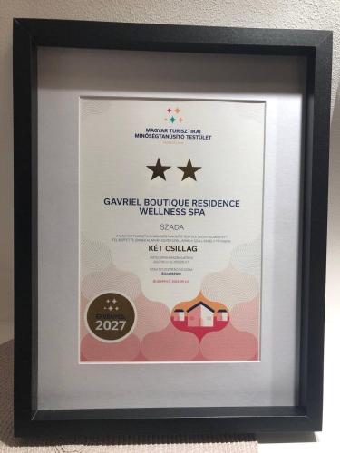 a framed picture of a certificate in a black frame at Gavriel Boutique Residence Wellness Spa in Szada