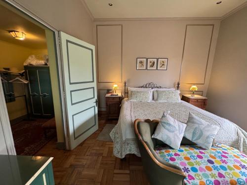a bedroom with a bed and a chair in it at Casona Lo Aguirre , Hospedaje de Temporada Cálidas in Talagante