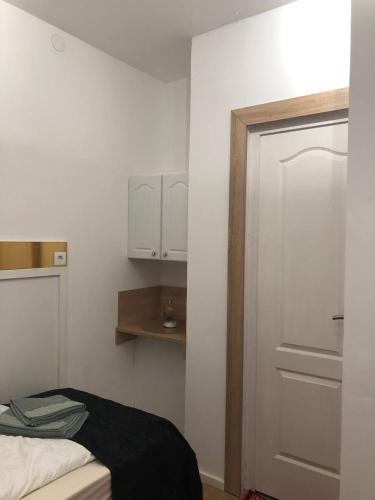 a bedroom with a bed and a door and a shelf at Gavriel Boutique Residence Wellness Spa in Szada