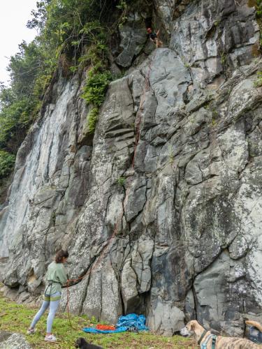 a woman holding a rope attached to a rock wall at Los Quetzales Ecolodge & Spa in Cerro Punta