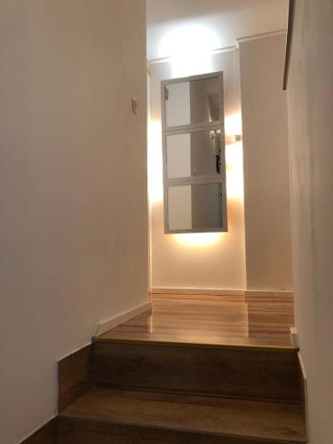 a hallway with a stair with a mirror and a light at Gavriel Boutique Residence Wellness Spa in Szada