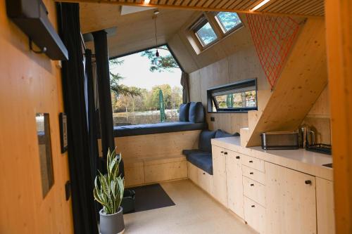 an interior view of a tiny house with a window at Tiny House Pioneer 2 - Green Tiny Spot Friesland in Schortens