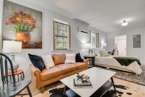 a living room with a couch and a table at Private Porch! Cozy East ATL Stay Near World Cup in Atlanta