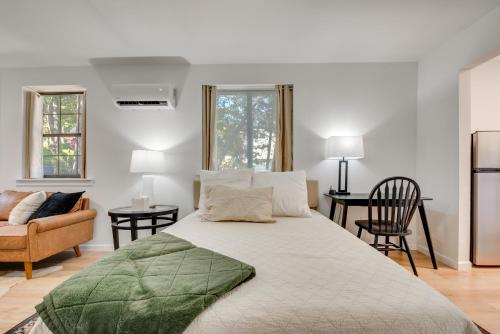 a white bedroom with a large bed and a chair at Private Porch! Cozy East ATL Stay Near World Cup in Atlanta