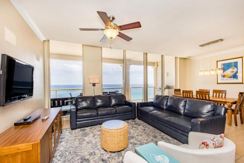 a living room with a couch and a flat screen tv at Beach Club Gulf Front 3B Condo - 1602 in Pensacola Beach