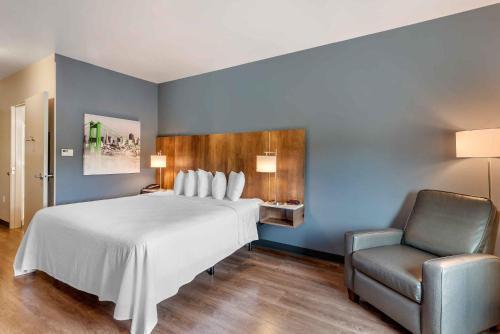 a bedroom with a large white bed and a chair at Extended Stay America Premier Suites - San Antonio - Schertz in Schertz