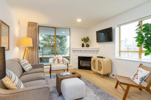 a living room with a couch and a fireplace at Renovated 2Bed-2Bath in Village with Pool, Hot Tub, and Sauna in Whistler