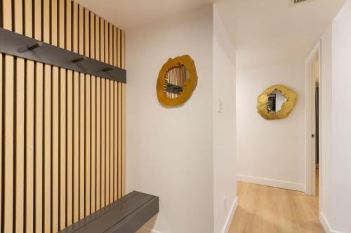a room with a staircase and two wreathes on the wall at Renovated 2Bed-2Bath in Village with Pool, Hot Tub, and Sauna in Whistler