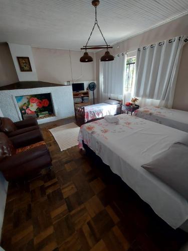 a bedroom with a large bed and a chair at Hotel Dom Paulo in Lapa