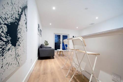 a white room with a ladder and a painting on the wall at Casa Canal in North Miami Beach