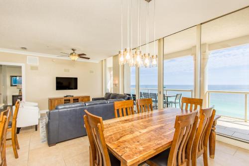 a dining room and living room with a table and chairs at Beach Club Gulf Front 3B Condo - 1602 in Pensacola Beach