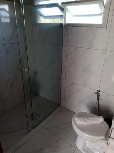 a bathroom with a shower and a toilet at Casa Lar Azul in Rio Forcação