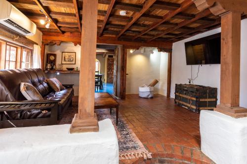 a living room with a couch and a tv at Casa Corazon in Santa Fe