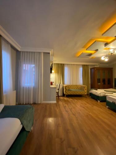 a large room with two beds and a couch at Pembe Köşk Old City Center in Istanbul