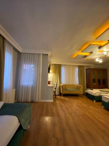 a large room with two beds and a couch at Pembe Köşk Old City Center in Istanbul