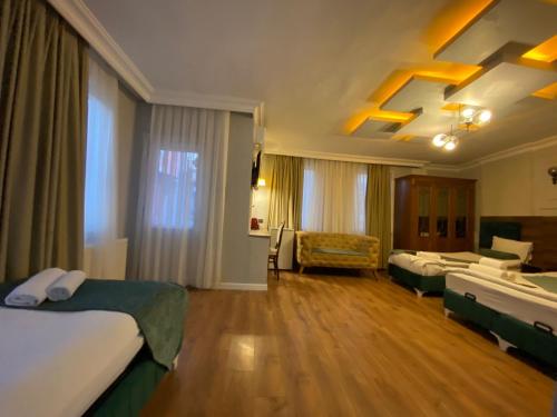 a hotel room with two beds and a couch at Pembe Köşk Old City Center in Istanbul