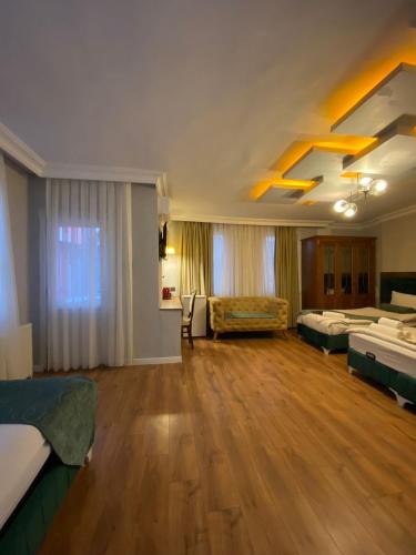 a large room with beds and a couch in it at Pembe Köşk Old City Center in Istanbul