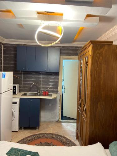 a kitchen with blue cabinets and a white refrigerator at Pembe Köşk Old City Center in Istanbul
