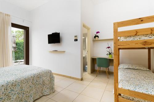 a bedroom with a bunk bed and a desk at Delle Rose, Hotel & Horse Riding in Torre Vado
